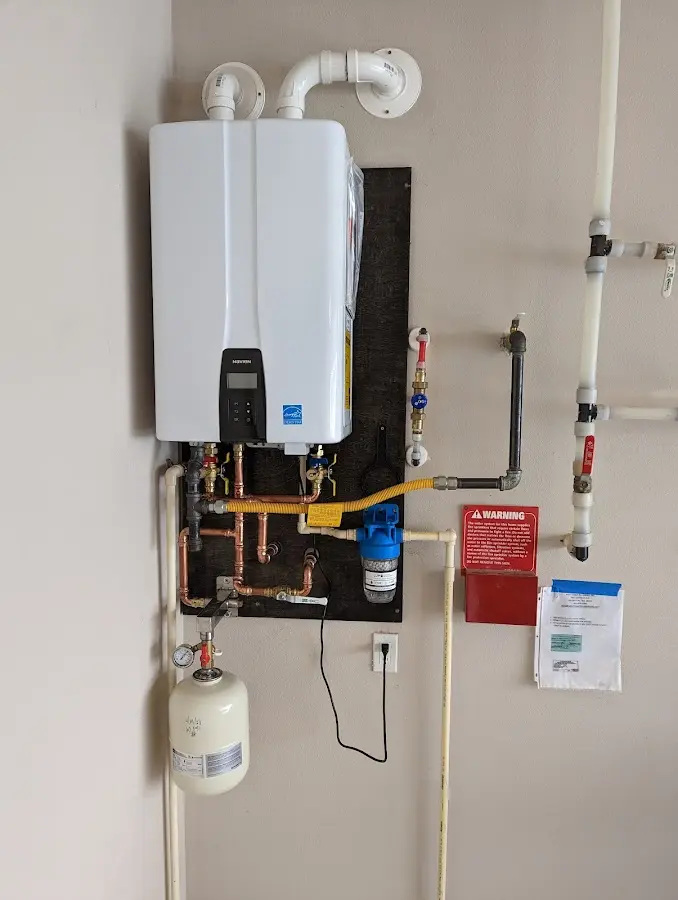 Professional plumber installing copper piping in a Reidland home